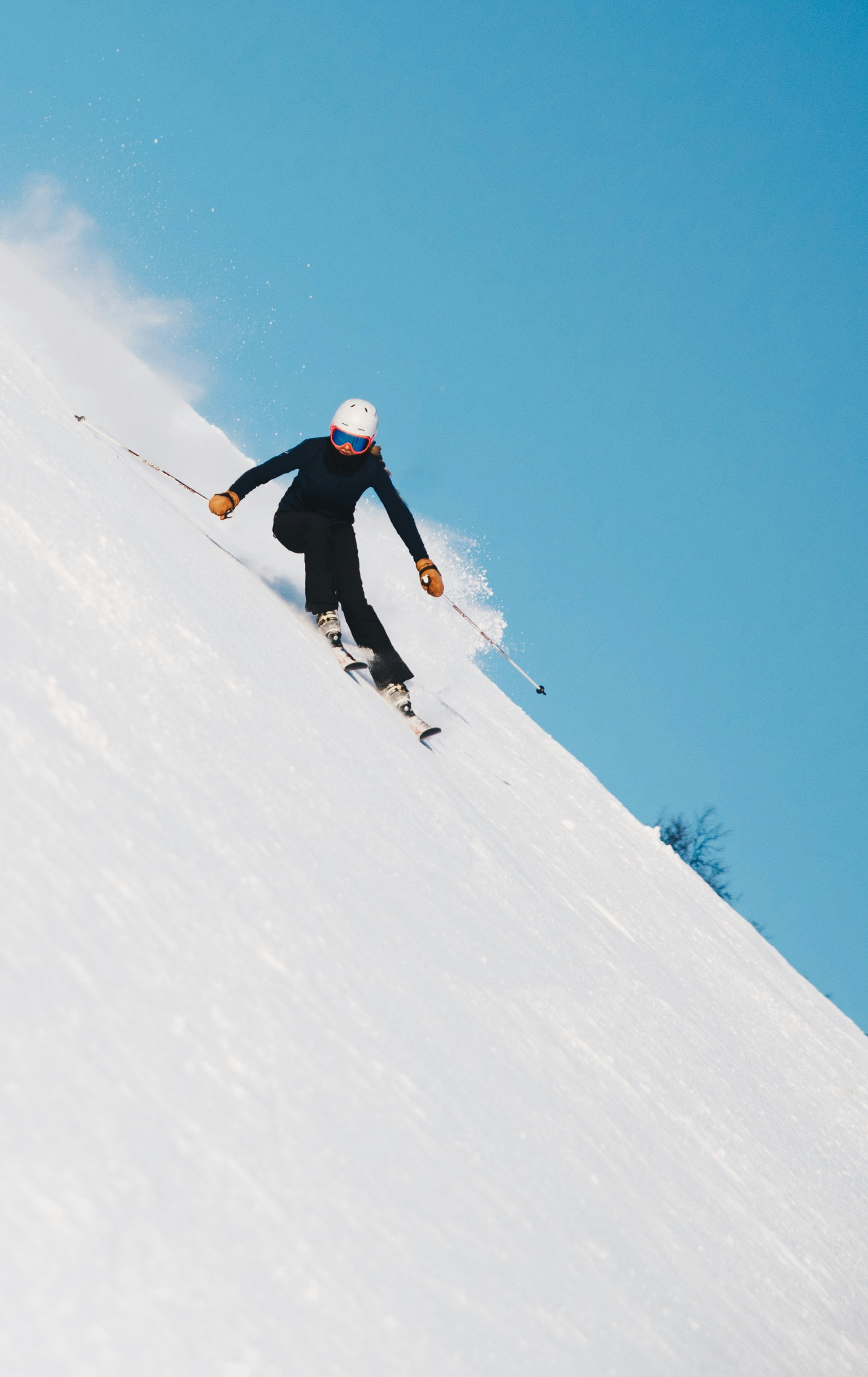 Skier carving on a groomed piste in Les Arcs ski resort, Paradiski area, French Alps